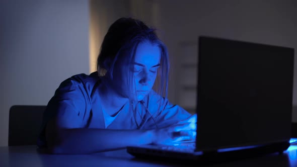 Tired Doctor Assistant Keeping Medical Records on Laptop and Falling Asleep