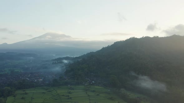 Drone Flight Over Misty Landscape Of Fields