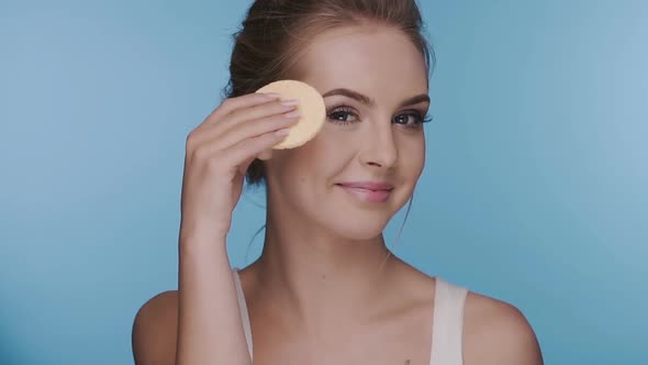 Brunette Removing Make-up Showing Her Sponge Into the Camera