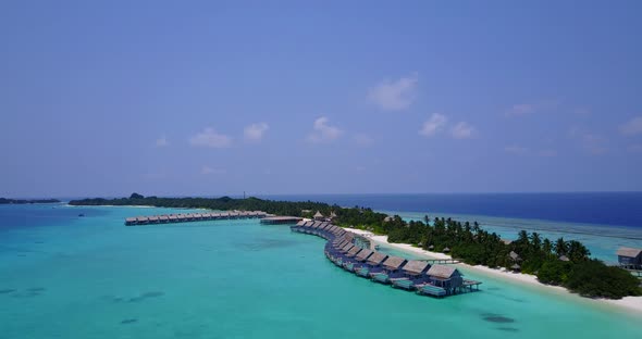 Beautiful flying abstract view of a white sand paradise beach and blue sea background in colorful 4K