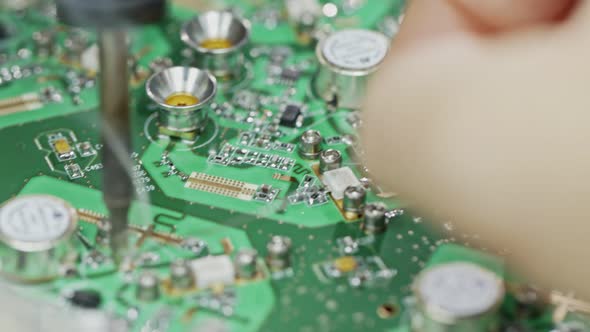 Close up of manual soldering of a large circuit board