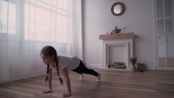 Girl Child Broadcasts an Online Course and Writes a Vlog About Gymnastics at Home