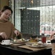 Mother and Daughter Have a Delicious Meal in a Cafe - VideoHive Item for Sale