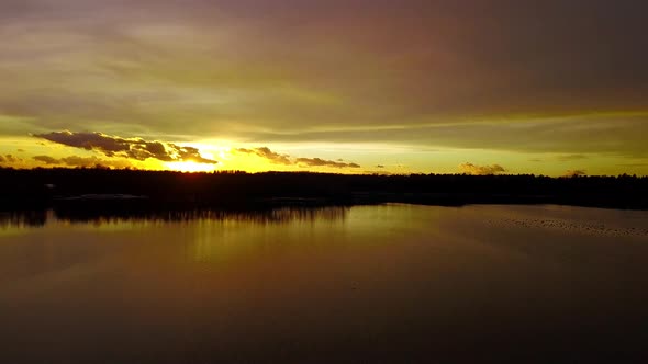 Hovering Over a Large and Big Lake at Sunset