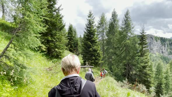 Back View of Family During a Mountain Trip Along Italian Alps Summer Season