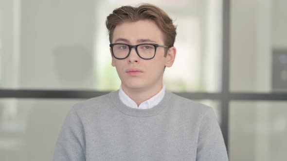 Portrait of Young Man Shaking Head As No Sign Denial