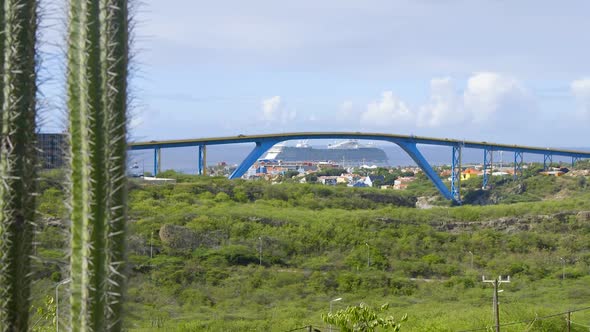 View looking over Willemstad and the Queen Juliana Bridge with a cruise ship in the background on th