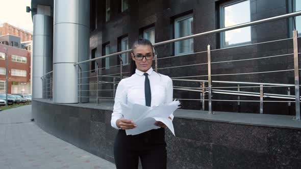 Office Woman in Busy Motion at Rush Hours By Drop Documents Paper To the Floor in Public Place