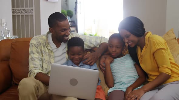 Family using laptop in living room 4k