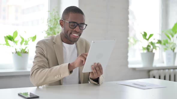 African Man Using Tablet While Sitting in Office