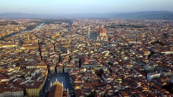 Basilica of Santa Croce front and Duomo Fiore cathedral far back right, Aerial flyover approach shot