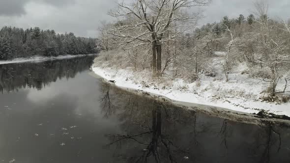 Calm waters of Piscataquis river in winter. Maine. USA. Aerial dolly in