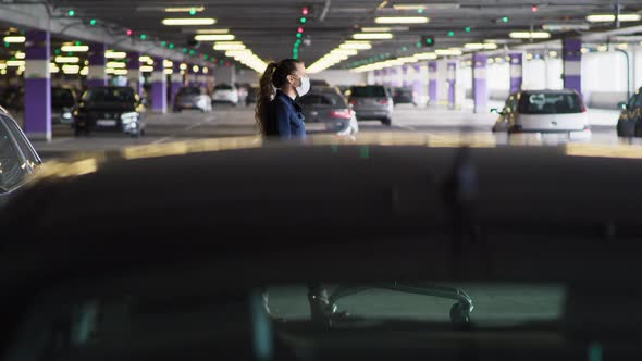 Side view of woman walking with shopping cart on parking. Shot with RED helium camera in 8K.