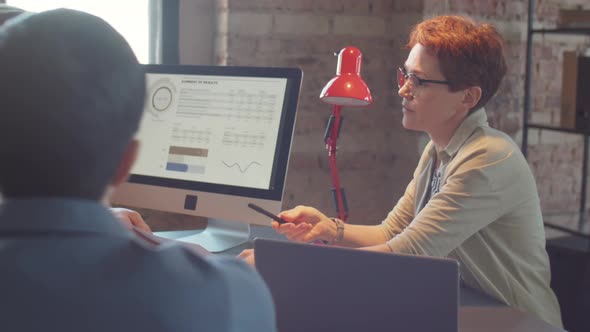 Businesswoman Holding Team Meeting in Office