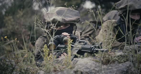 Israeli soldiers in a surveillance and reconnaissance mission using binoculars