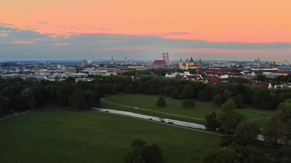 Aerial of Munich in the early sunlight. Sunrise over the Englischer Garten with the view at the popu