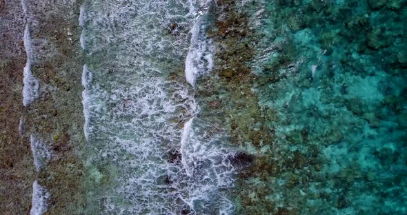 Tropical drone travel shot of a white paradise beach and blue water background