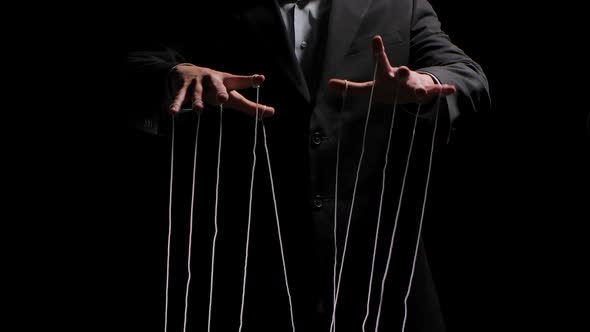 Puppeteer Pulls the Doll Strings Tied To His Fingers