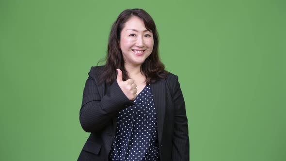 Mature Beautiful Asian Businesswoman Giving Thumbs Up