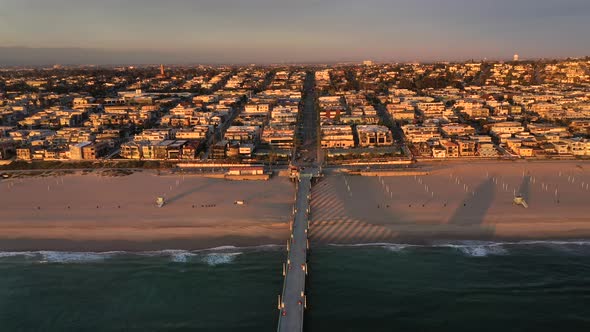 Manhattan Beach Pier At Sunset In Los Angeles, California - aerial pullback