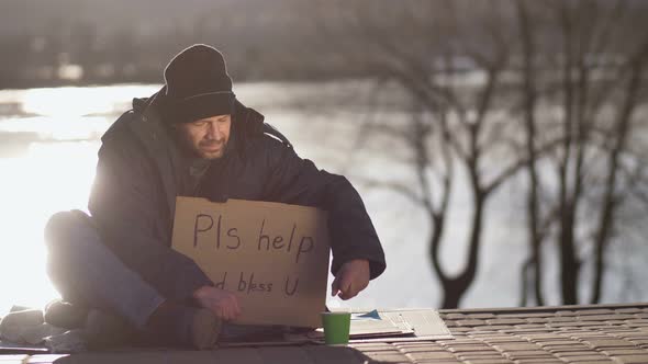 Homeless Begging Man Hiding Cash in His Pocket