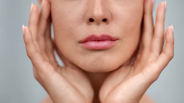 Extreme Closeup Feminine Lips and Chin Applying Anti Aging Cream on Face Skin