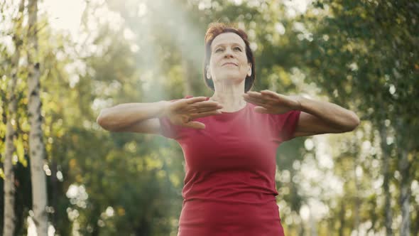 Elderly Woman Do Exercises on Nature