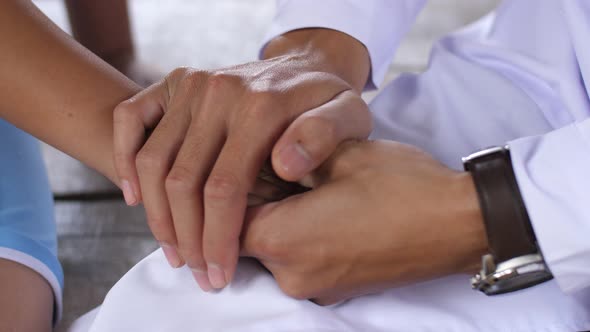 Hand Of Doctor Reassuring His Boy Patient