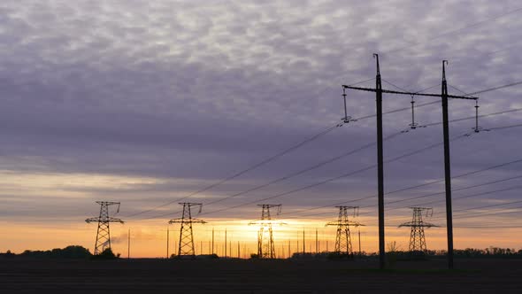 Time Lapse. Electricity pylons. Sunrise sky