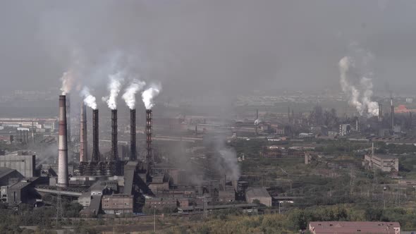 Air pollution by smoke pipes on the background of the city