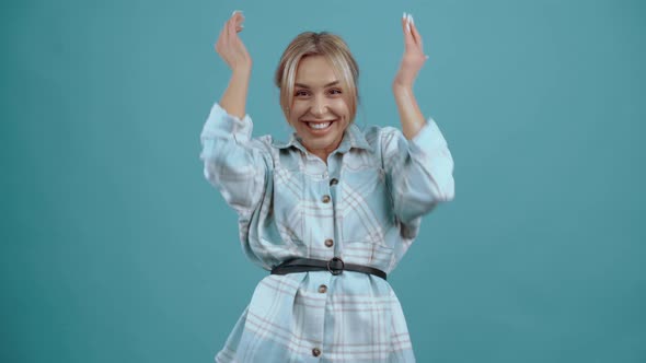 The Beautiful Happy Winning Young Woman Raises Her Hands Up Like a Gesture of Victory