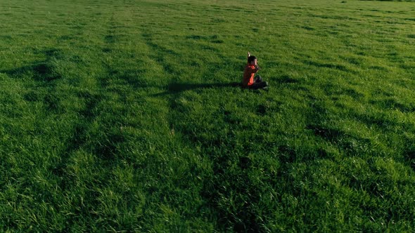 Low Altitude Radial Flight Over Sport Yoga Man at Perfect Green Grass