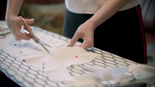 Young Woman Cutting the Cloth Following the Soap Marks