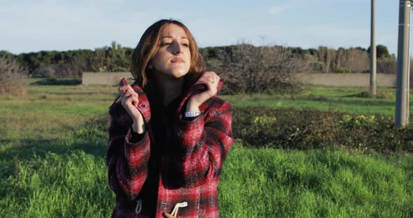 Girl walks and enjoying life in a green field