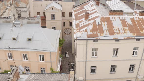 Newlyweds Aerial View Groom Bride Walking Dancing Kissing on City Street Wedding Couple in Love