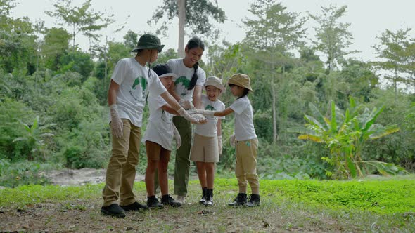 Children volunteering for community activities are hands holding together to join forces