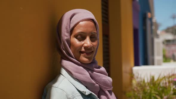 Young woman wearing hijab out and about in the city