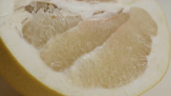 Opened  Citrus maxima grandis 4K 2160p 30fps UltraHD  tilting footage - Juicy surface of pomello fru