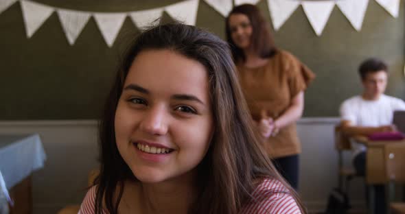 Portrait of teenage girl in a school classroom alt