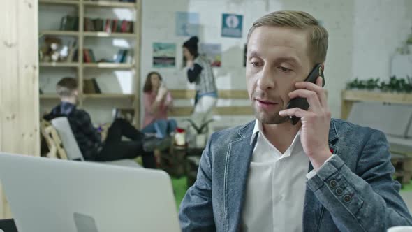 Trendy Businessman Working at Desk