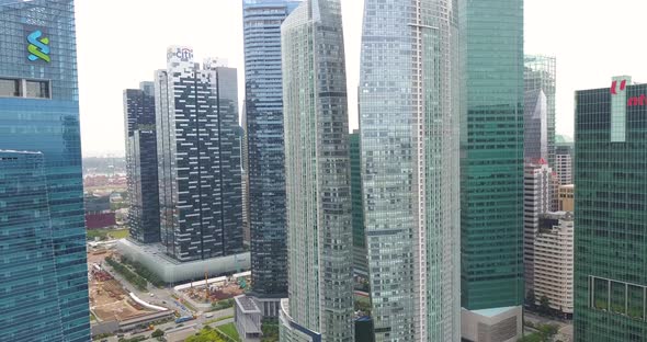 Aerial Shooting of the Flight Between the Skyscrapers in the Business District of Singapore