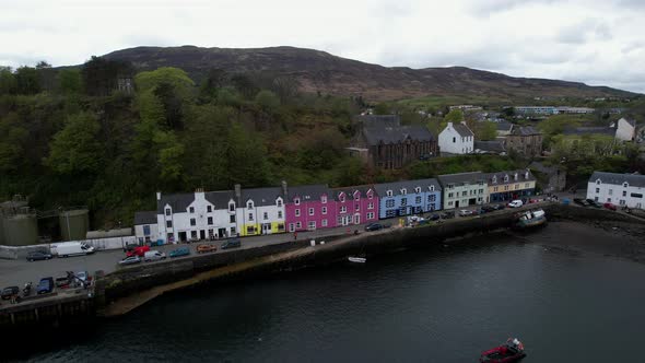 Beautiful Scottish Portree harbour picturesque colourful coastal vacation houses aerial view rising