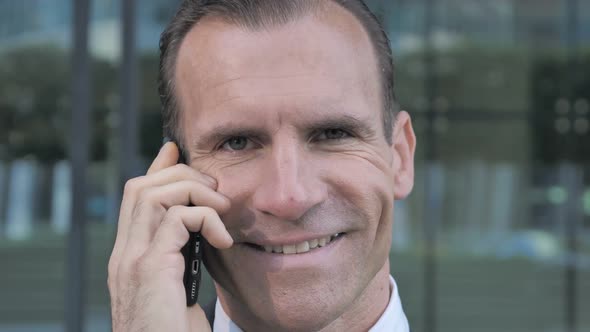 Middle Aged Businessman Talking on Phone