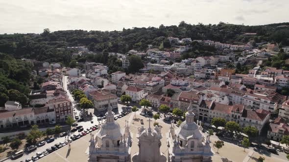 Birds eye view from the top of historic Alcobaca monastery overlooking at the parish townscape.
