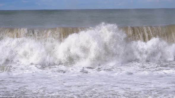 Storm on the Sea. Huge Waves Are Crashing and Spraying on the Shore. Slow Motion