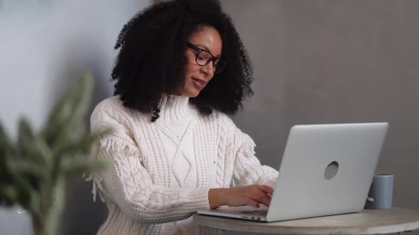 African Woman Young American is Working with Laptop at Table in Modern Office Spbi