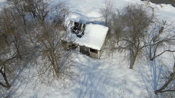 Aerial View of Scary Old Burnt House in Winter