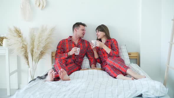 Young Happy Couple Having Breakfast in Bed