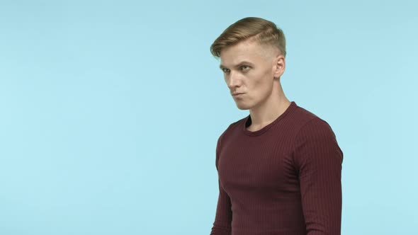 Handsome and Confident Blond Man Ready for Fight Standing in Boxer Pose with Raised Clenched Fists