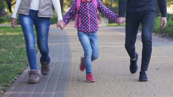 Happy Girl Walking With Parents After School, Boasting of Interesting Classes